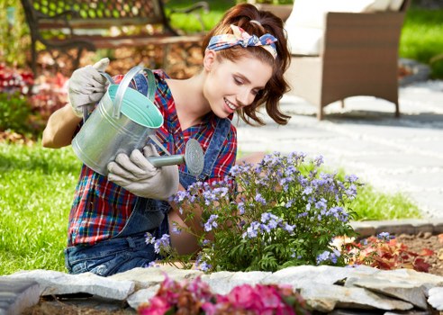Team member carrying out garden maintenance with safety awareness